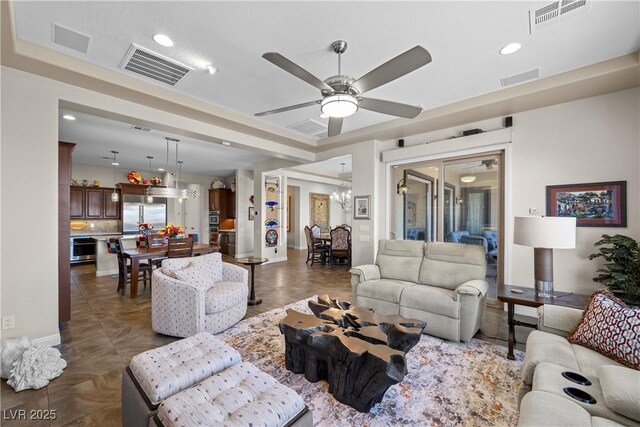 2749 Liberation Dr, Henderson, NV 89044 - living area featuring a chandelier, a ceiling fan, baseboards, and recessed lighting