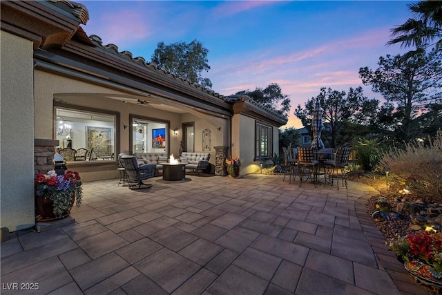 2749 Liberation Dr, Henderson, NV 89044 - patio terrace at dusk with an outdoor living space, a patio, outdoor dining space, and ceiling fan