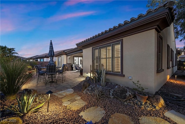 2749 Liberation Dr, Henderson, NV 89044 - back of house featuring stucco siding, a patio, and a tiled roof