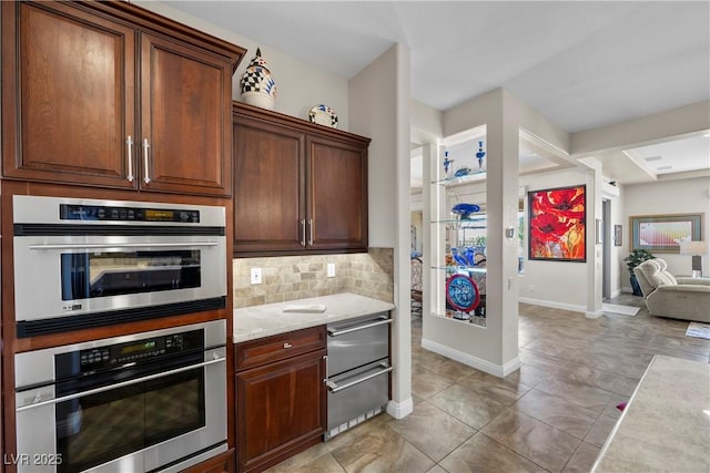 2749 Liberation Dr, Henderson, NV 89044 - kitchen featuring backsplash, baseboards, light tile patterned flooring, double oven, and a warming drawer