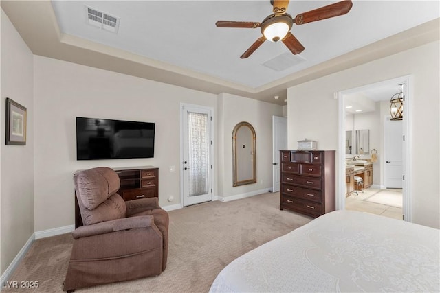 2749 Liberation Dr, Henderson, NV 89044 - bedroom with light colored carpet, baseboards, a tray ceiling, and ensuite bathroom