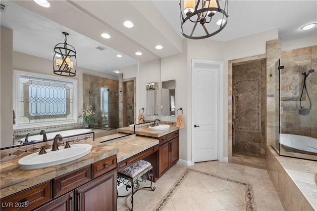 2749 Liberation Dr, Henderson, NV 89044 - full bath featuring a chandelier, recessed lighting, a garden tub, a shower stall, and vanity