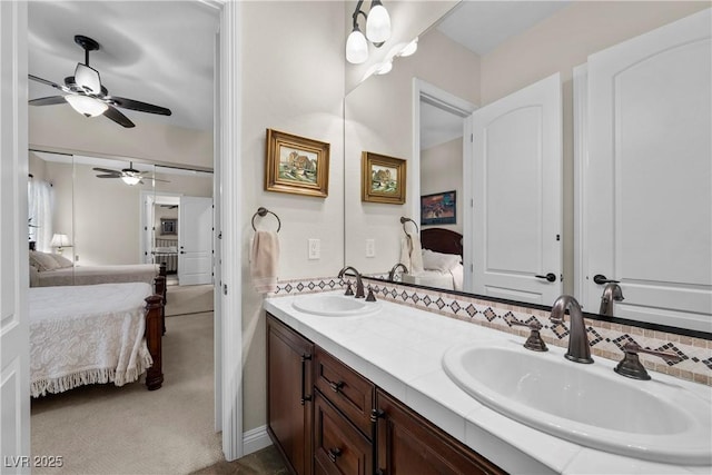 2749 Liberation Dr, Henderson, NV 89044 - bathroom with ensuite bath, ceiling fan, and double vanity