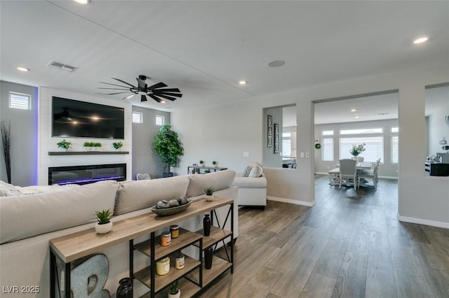 7077 Sunland Hills Ave, Las Vegas, NV 89113 - living room with a glass covered fireplace, recessed lighting, wood finished floors, baseboards, and a ceiling fan