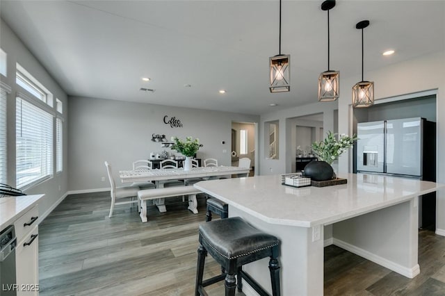 7077 Sunland Hills Ave, Las Vegas, NV 89113 - kitchen with a center island, dark wood-style flooring, light countertops, recessed lighting, and hanging light fixtures
