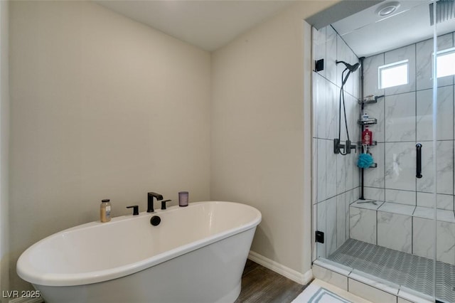 7077 Sunland Hills Ave, Las Vegas, NV 89113 - full bath with a freestanding tub, a shower stall, baseboards, and wood finished floors