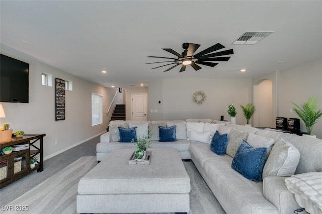 7077 Sunland Hills Ave, Las Vegas, NV 89113 - living room featuring stairs, light colored carpet, ceiling fan, recessed lighting, and arched walkways