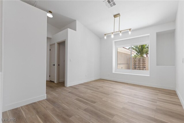 8032 Deep Stone Ave, Las Vegas, NV 89149 - unfurnished room featuring light wood finished floors, baseboards, and vaulted ceiling