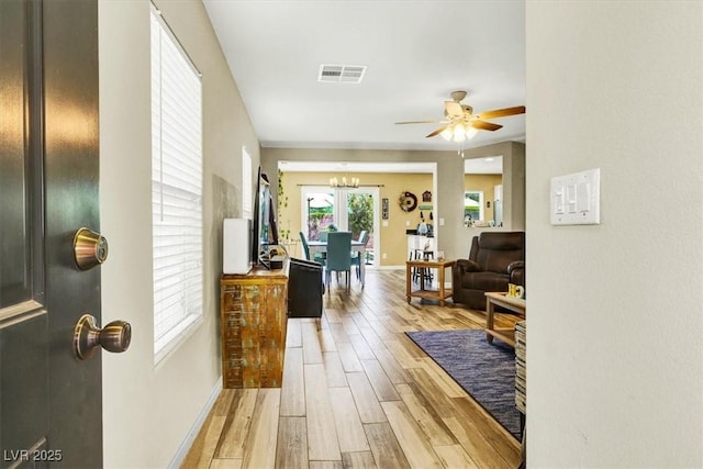 9236 Keystone Ridge Ave, Las Vegas, NV 89148 - corridor with a chandelier, light wood-style floors, and baseboards