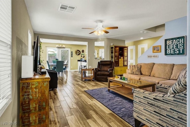 9236 Keystone Ridge Ave, Las Vegas, NV 89148 - living area featuring wood finished floors, a chandelier, a ceiling fan, and baseboards