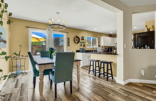 9236 Keystone Ridge Ave, Las Vegas, NV 89148 - dining area featuring a chandelier, light wood-type flooring, baseboards, and recessed lighting