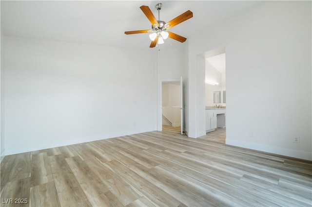 827 Happy Sparrow Ave, Henderson, NV 89052 - spare room with light wood-type flooring, ceiling fan, vaulted ceiling, and baseboards