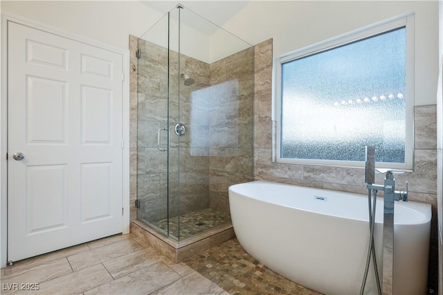 827 Happy Sparrow Ave, Henderson, NV 89052 - bathroom featuring a shower stall, a soaking tub, and tile walls