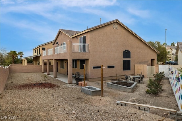 827 Happy Sparrow Ave, Henderson, NV 89052 - back of property with a balcony, a patio, a fenced backyard, and stucco siding