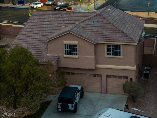 827 Happy Sparrow Ave, Henderson, NV 89052 - view of side of home with an attached garage, driveway, stucco siding, and cooling unit