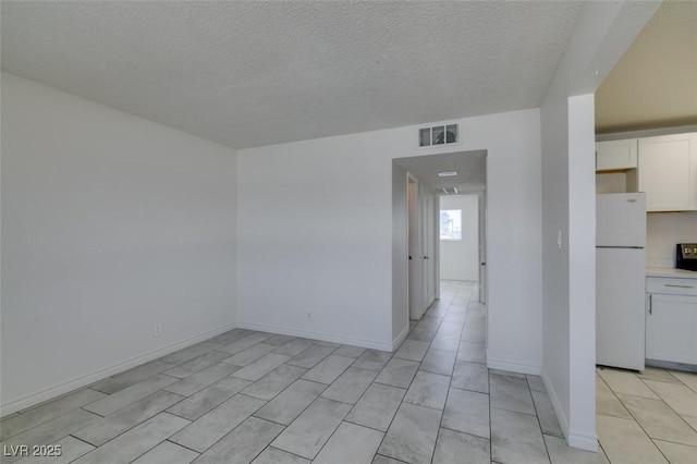 212 Orland St Unit 28, Las Vegas, NV 89107 - unfurnished room with a textured ceiling, baseboards, and light tile patterned floors