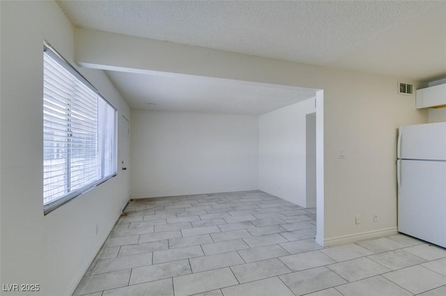 212 Orland St Unit 28, Las Vegas, NV 89107 - spare room with plenty of natural light, a textured ceiling, and baseboards