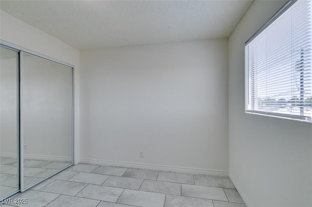 212 Orland St Unit 28, Las Vegas, NV 89107 - unfurnished bedroom featuring a closet, a textured ceiling, and baseboards