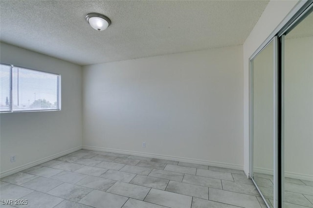 212 Orland St Unit 28, Las Vegas, NV 89107 - unfurnished bedroom featuring a textured ceiling, a closet, and baseboards