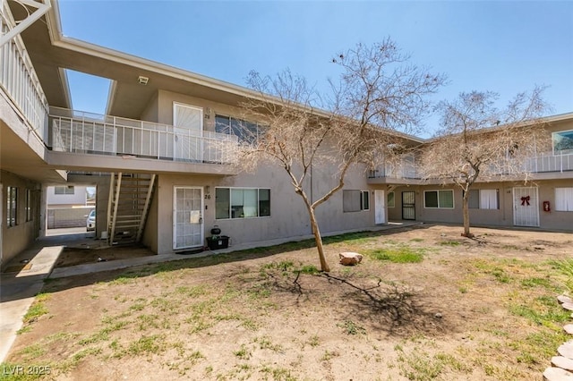 212 Orland St Unit 28, Las Vegas, NV 89107 - rear view of house featuring stairs and stucco siding