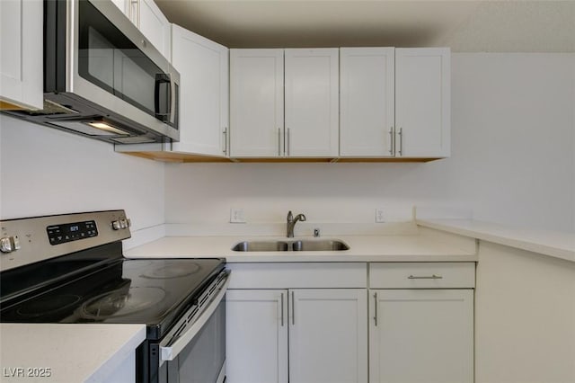 212 Orland St Unit 28, Las Vegas, NV 89107 - kitchen with stainless steel appliances, a sink, white cabinetry, and light countertops