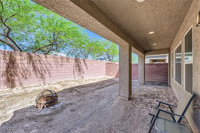 8121 Russell Creek Ct, Las Vegas, NV 89139 - fenced backyard with a fire pit and a patio