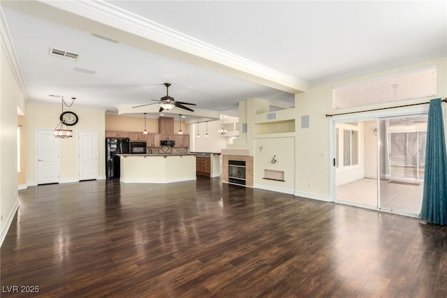 6779 Rainstorm Ridge Ave, Las Vegas, NV 89131 - unfurnished living room featuring ornamental molding, a chandelier, a ceiling fan, dark wood finished floors, and a tiled fireplace