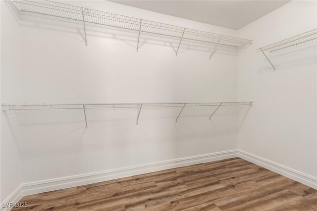 6779 Rainstorm Ridge Ave, Las Vegas, NV 89131 - walk in closet featuring wood finished floors