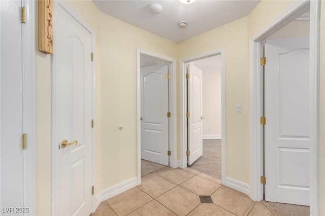 6779 Rainstorm Ridge Ave, Las Vegas, NV 89131 - corridor featuring light tile patterned floors and baseboards