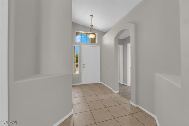 3228 Jumping Hills Ave, Henderson, NV 89052 - entryway featuring arched walkways, light tile patterned floors, baseboards, and vaulted ceiling