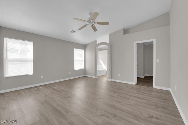 3228 Jumping Hills Ave, Henderson, NV 89052 - empty room featuring a ceiling fan, arched walkways, wood finished floors, lofted ceiling, and baseboards