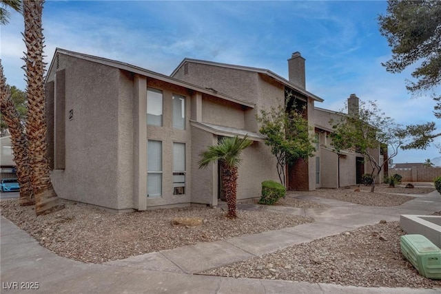 573 Sellers Pl, Henderson, NV 89011 - view of side of home with stucco siding and a chimney