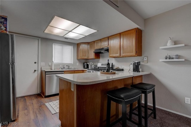 573 Sellers Pl, Henderson, NV 89011 - kitchen featuring stainless steel dishwasher, stove, a peninsula, freestanding refrigerator, and light countertops