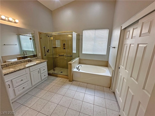 316 Lingering Ln, Henderson, NV 89012 - bathroom featuring a garden tub, double vanity, tile patterned floors, a shower stall, and plenty of natural light