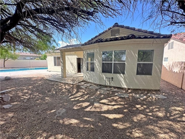 316 Lingering Ln, Henderson, NV 89012 - rear view of property with a fenced backyard, a tiled roof, and a patio area