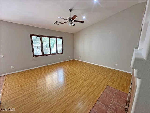316 Lingering Ln, Henderson, NV 89012 - empty room featuring a ceiling fan, light wood-style flooring, baseboards, and vaulted ceiling