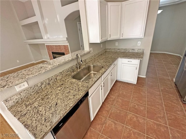 316 Lingering Ln, Henderson, NV 89012 - kitchen featuring a sink, stainless steel dishwasher, white cabinetry, and light stone countertops