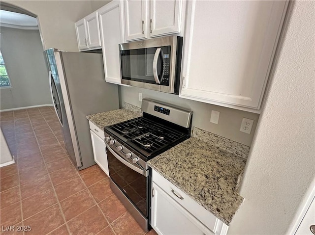 316 Lingering Ln, Henderson, NV 89012 - kitchen with appliances with stainless steel finishes, white cabinets, tile patterned flooring, and light stone counters