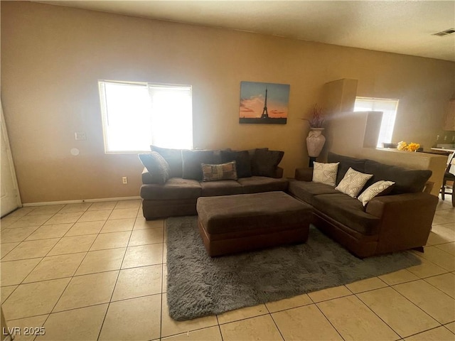 1667 Marion Bennet Dr, Las Vegas, NV 89106 - living room featuring healthy amount of natural light, light tile patterned flooring, and baseboards