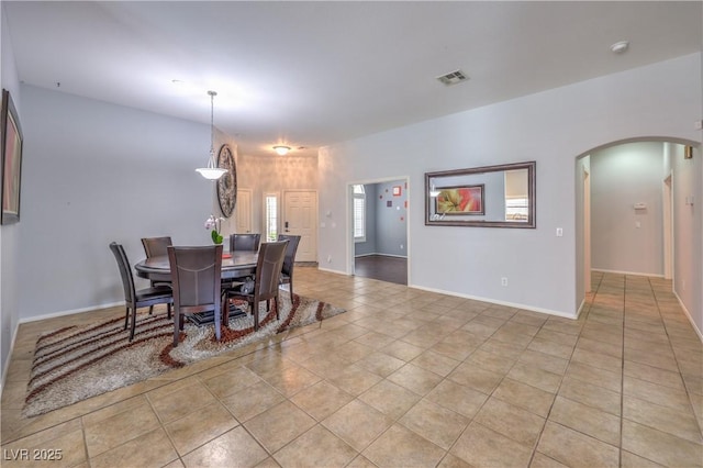 7427 Page Ranch Ct, Las Vegas, NV 89131 - dining area featuring arched walkways, baseboards, and light tile patterned floors
