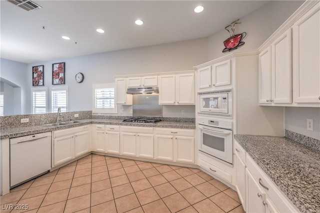 7427 Page Ranch Ct, Las Vegas, NV 89131 - kitchen with white appliances, a sink, arched walkways, white cabinets, and recessed lighting