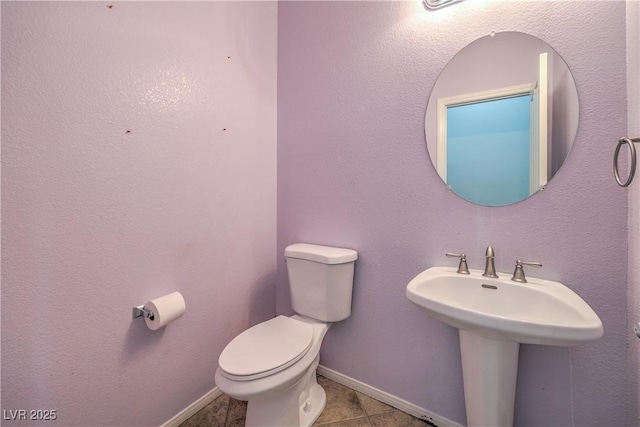 7427 Page Ranch Ct, Las Vegas, NV 89131 - half bathroom with toilet, baseboards, and tile patterned flooring