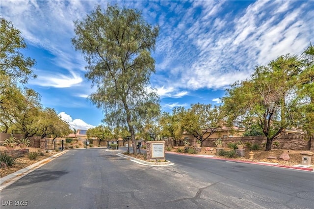 7427 Page Ranch Ct, Las Vegas, NV 89131 - view of asphalt street with curbs, a gated entry, and a gate