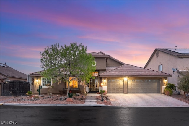 5940 Vizzi Ct, Las Vegas, NV 89131 - ranch-style house featuring an attached garage, driveway, stucco siding, and a gate