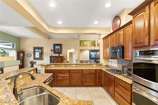 5940 Vizzi Ct, Las Vegas, NV 89131 - kitchen featuring stainless steel appliances, a sink, light stone countertops, light tile patterned flooring, and a peninsula