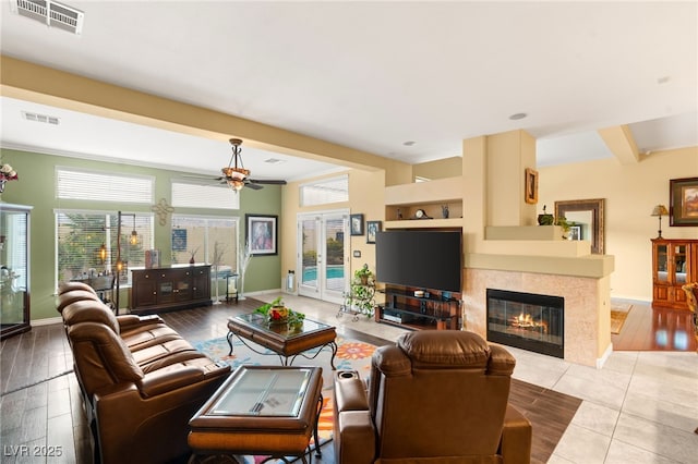 5940 Vizzi Ct, Las Vegas, NV 89131 - living room with a ceiling fan, a fireplace, baseboards, and tile patterned floors