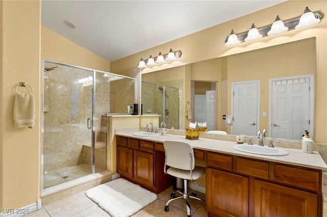 5940 Vizzi Ct, Las Vegas, NV 89131 - bathroom featuring double vanity, tile patterned floors, a shower stall, and lofted ceiling