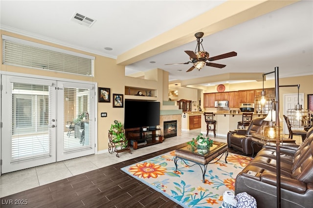 5940 Vizzi Ct, Las Vegas, NV 89131 - living room featuring french doors, a ceiling fan, ornamental molding, baseboards, and wood finished floors