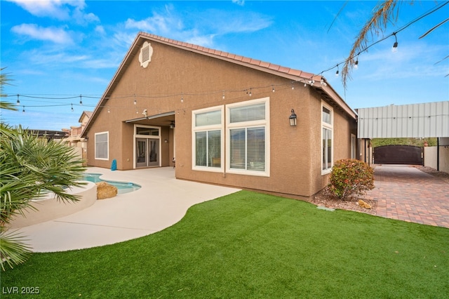 5940 Vizzi Ct, Las Vegas, NV 89131 - rear view of property featuring stucco siding and a patio area