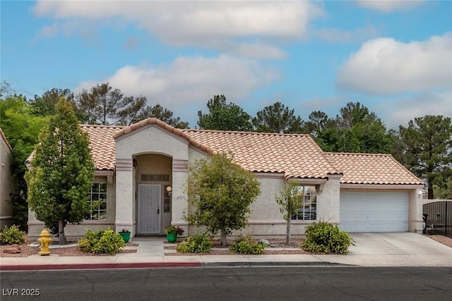 3157 Capetown Way, Las Vegas, NV 89128 - mediterranean / spanish house featuring an attached garage, a tile roof, concrete driveway, and stucco siding